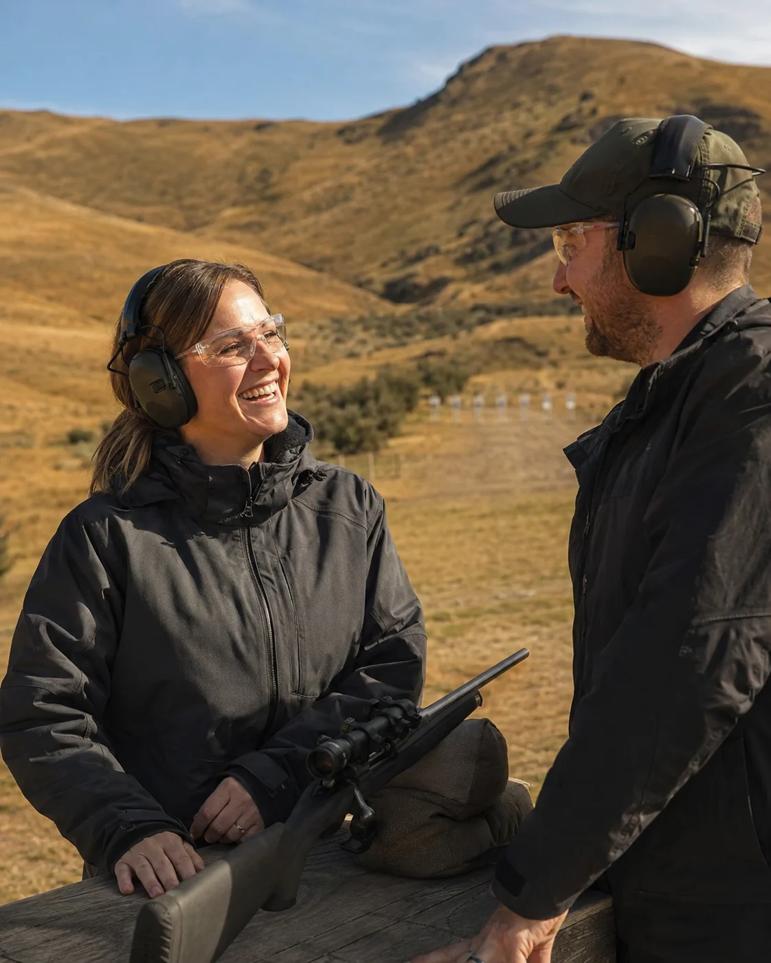Concept of a visitor and instructor sharing a smile at an outdoor range